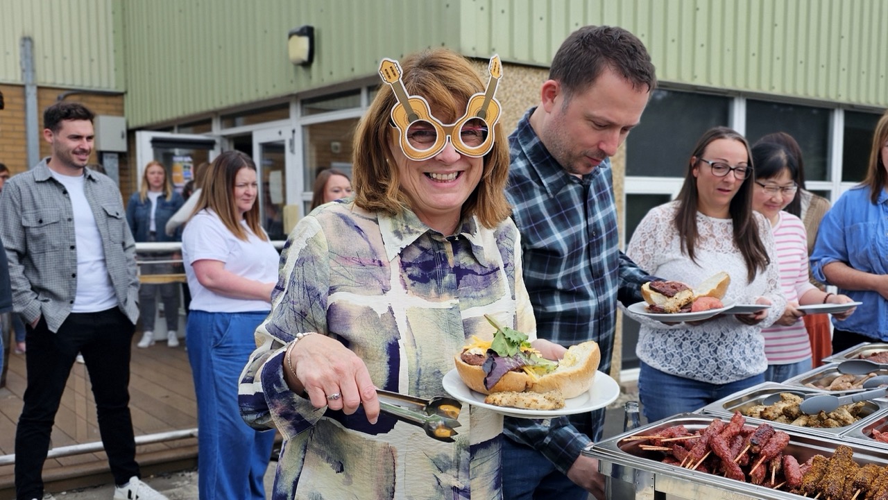 Image of members of the Drummond Laurie Chartered Accountants team tucking in to a meal to celebrate 13 years in business.